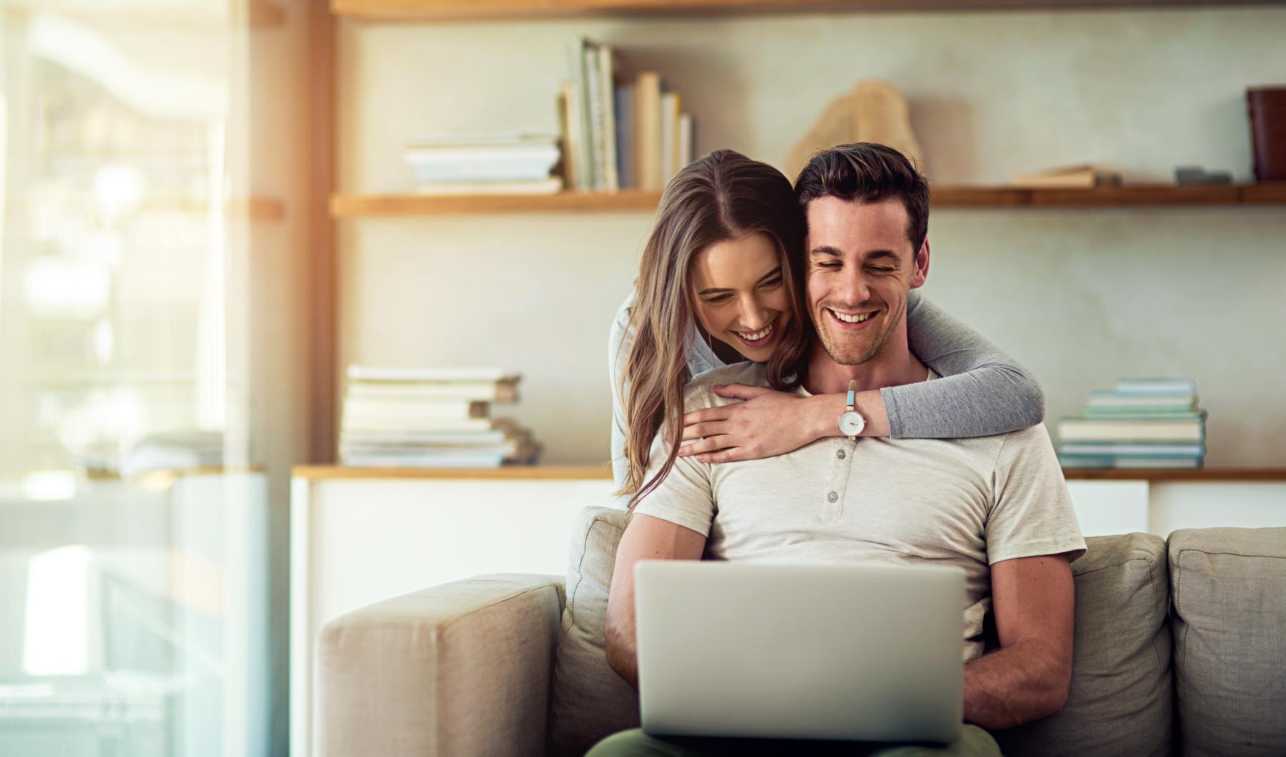 Find your perfect fit at Ariza Corpus South a man and a woman sitting on a couch looking at a laptop