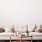 a white couch with a table and chairs in a room with plants