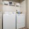 laundry closet with washer/dryer units and shelving