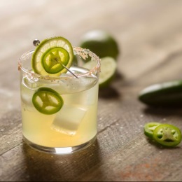 a drink with lime and peppers